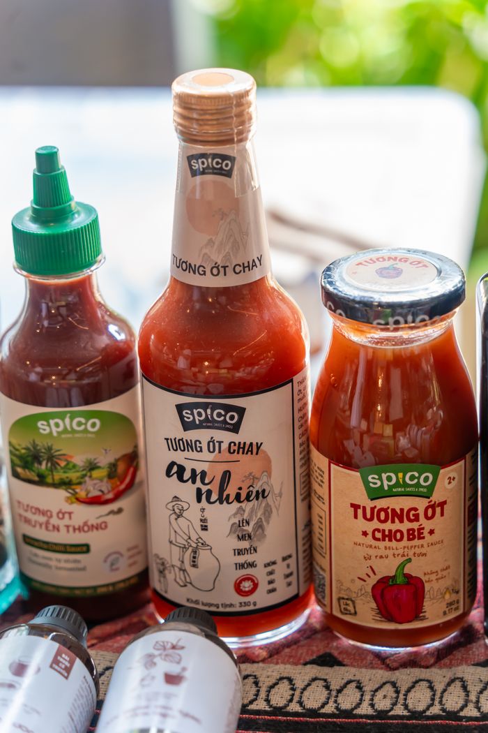 Selection of spicy condiments including chili sauce bottles, ideal for culinary and food photography.
